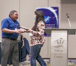 Former AFT-Oregon President Jaime Rodriguez awards a scholarship in 2022